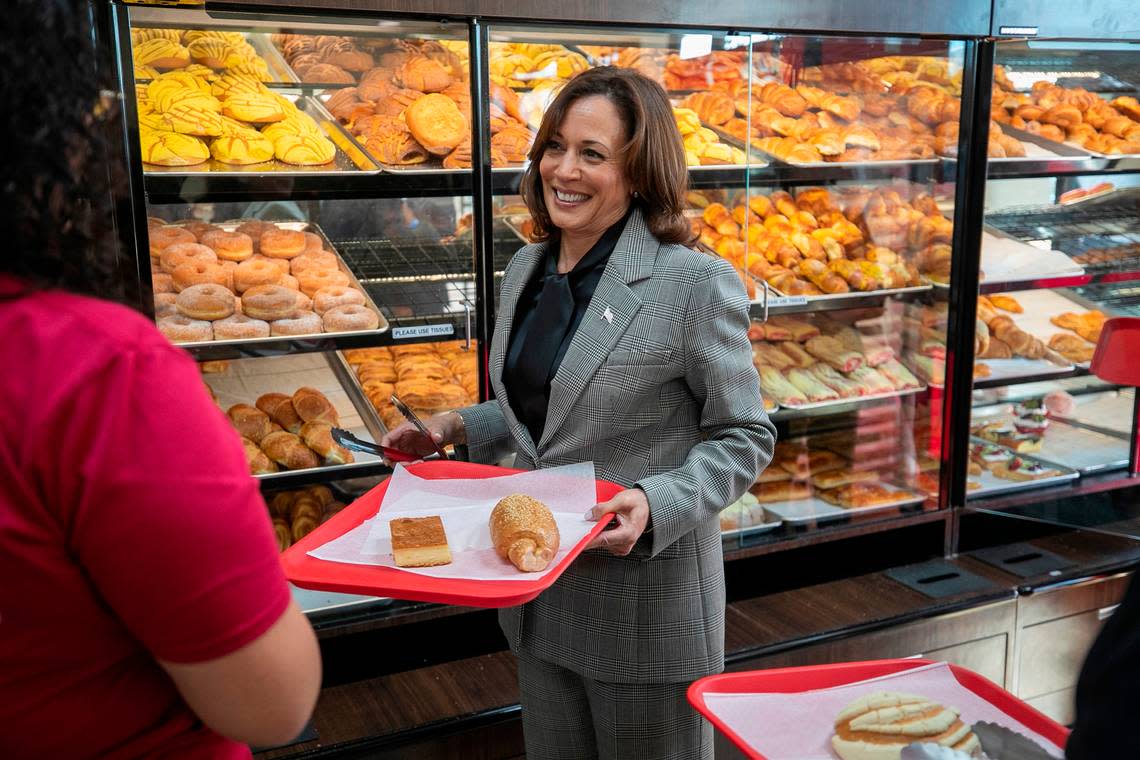 Astrid Sabillon, left, helps Vice President Kamala Harris during her visit to Panaderia Artisanal, a Latina-owned bakery on Monday, January 30, 2023 in Raleigh, N.C.