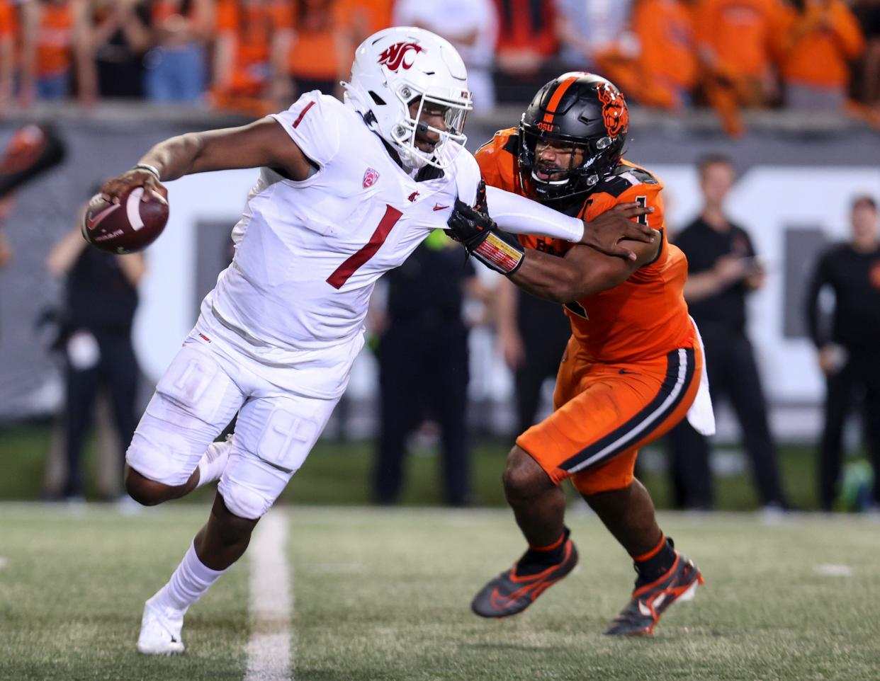 Washington State quarterback Cameron Ward (1) scrambles from Oregon State linebacker Omar Speights (1) during the fourth quarter at Reser Stadium at Oregon State University in Corvallis on Oct. 15, 2022.