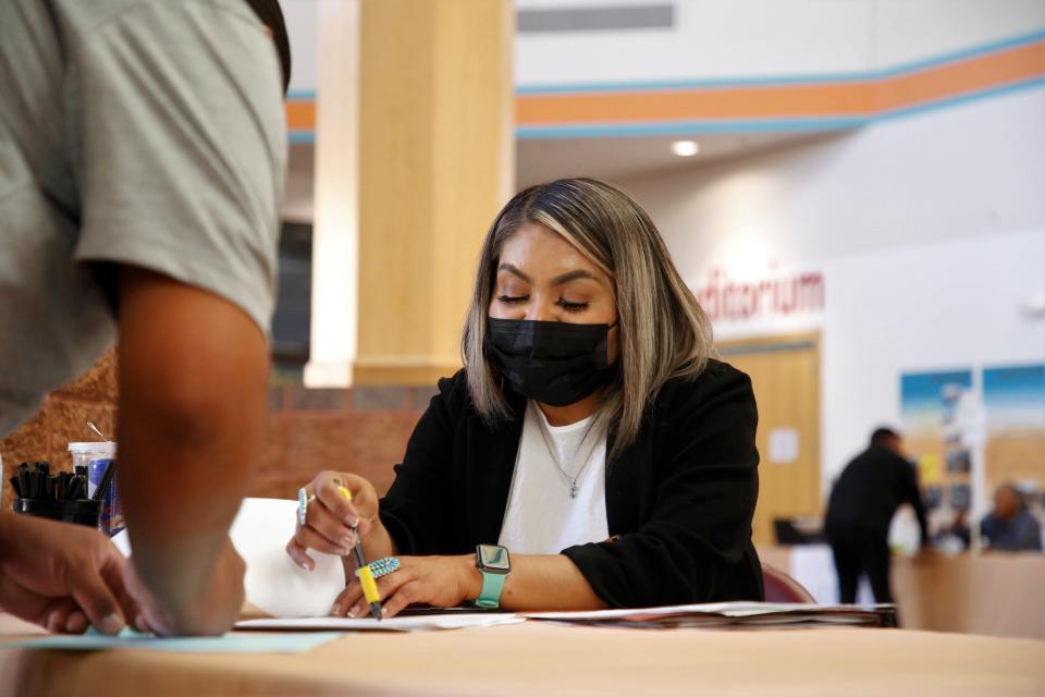 Marcy Yazzie, voter registration specialist with the Navajo Election Administration's Chinle Agency office, helps a candidate file forms for the Navajo Nation primary election on May 4 at the Navajo Nation Museum in Window Rock, Arizona.