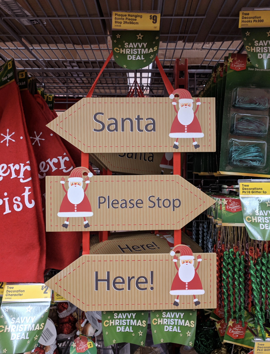 A three-way sign: "Santa" "Please Stop" "Here!"