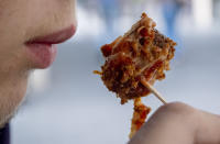 A vegan curry wurst is eaten at a "Best Worscht in Town" sausage franchise in Frankfurt, Germany, Wednesday, Sept. 13, 2023. Eating more plants and fewer animals is among the simplest, cheapest and most readily available ways for people to reduce their impact on the environment, climate scientists have long said. (AP Photo/Michael Probst)