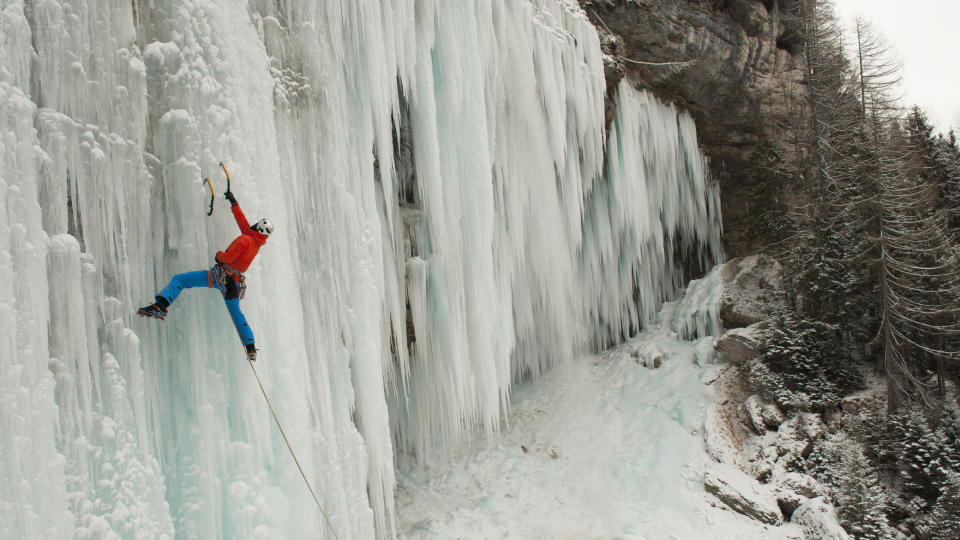 what is ice climbing: climber on frozen waterfall