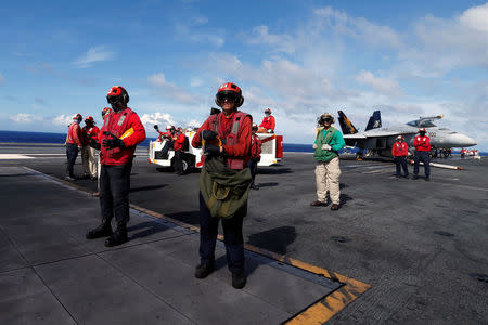 Crew members are seen on duty, on the deck of the USS Ronald Reagan, in the South China Sea September 30, 2017. REUTERS/Bobby Yip