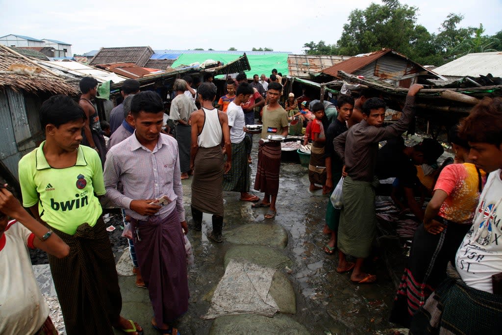 Internally displaced Rohingya walk at a market area in the Baw Du Pha IDP Camp in Sittwe in Myanmar’s western Rakhine state (AFP via Getty Images)