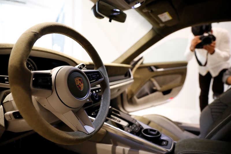 The logo of Porsche is pictured on the steering wheel of a Porsche 911 sports car on display at its dealership during a news conference in Seoul