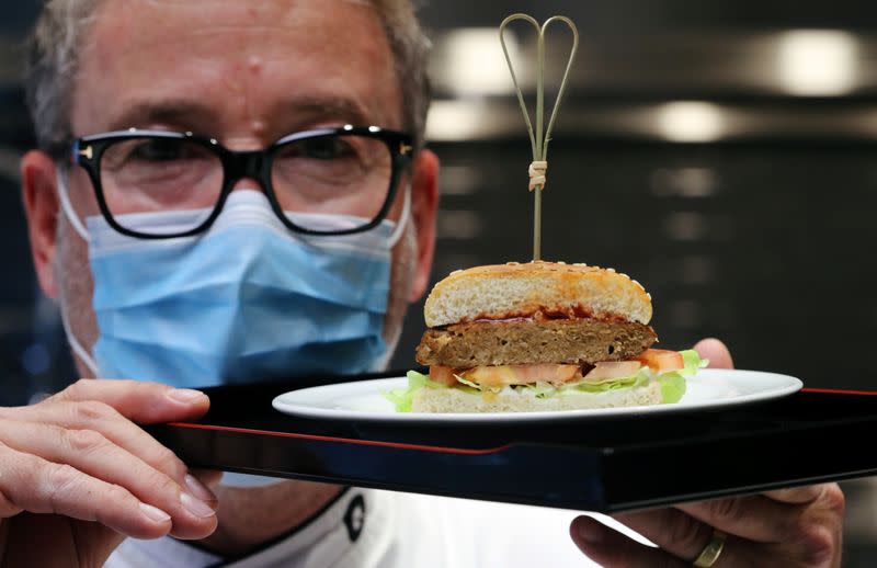 Chef Brunschweiler displays a pea protein-based hamburger at flavour maker Givaudan's innovation centre in Kemptthal