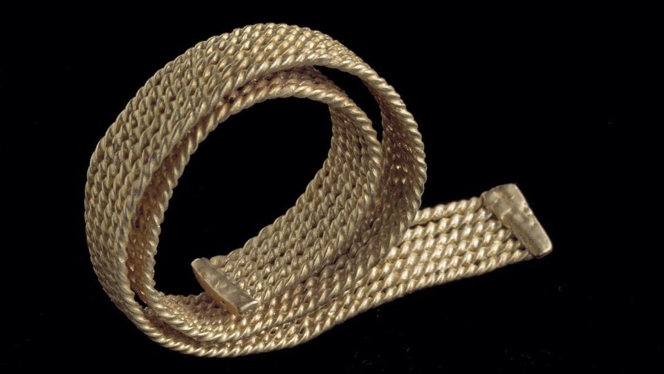 A photograph of a twisted gold bracelet