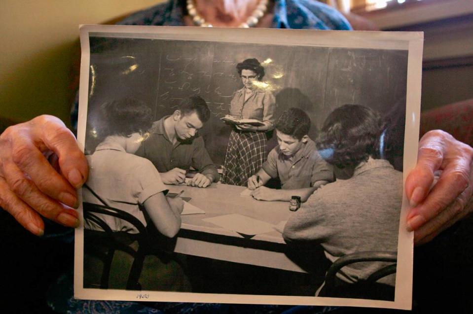 Marie Glick holds a photo of herself teaching at Masonic Home in 1953. Glick turned 100 Dec. 5, 2007.