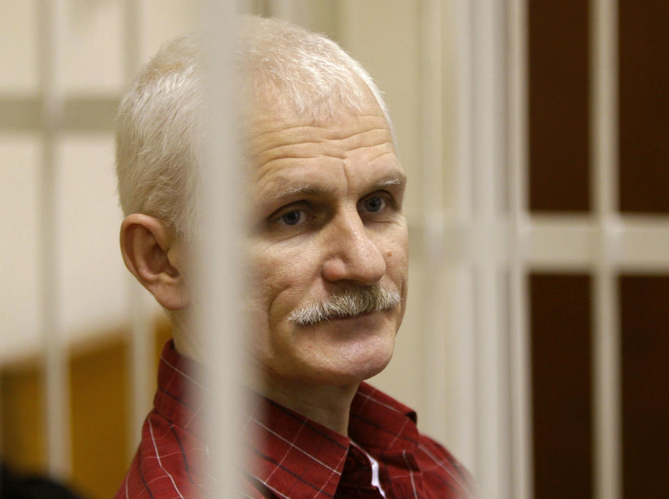 FILE - Ales Bialiatski, the head of Belarusian Viasna rights group, stands in a defendants' cage during a court session in Minsk, Belarus, on Nov. 2, 2011. The head of the Norwegian Nobel Committee on Friday, Oct. 6, 2023 urged Iran to release imprisoned peace prize winner Narges Mohammadi and let her accept the award at the annual prize ceremony in December. Such appeals have had little effect in the past. Belarussian pro-democracy campaigner Ales Bialiatski, who shared last year's Nobel Peace Prize with human rights groups in Russia and Ukraine was the fourth person to receive the award while in captivity. (AP Photo/Sergei Grits, File)