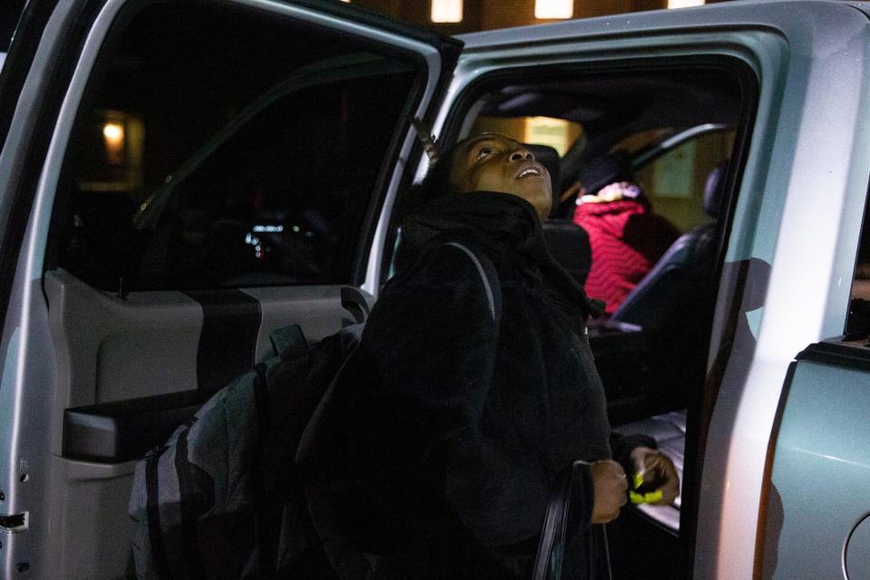 Chanel looks up at the stars as the sun begins to rise while she loads her belonging into the truck of a volunteer that will take her back downtown after she spent the night at Christ the King Lutheran Church through the Room In The Inn program in Memphis, Tenn., on Thursday, November 2, 2023. “Well, it looks like it’s going to be a good day today,” she said after looking at the sky.