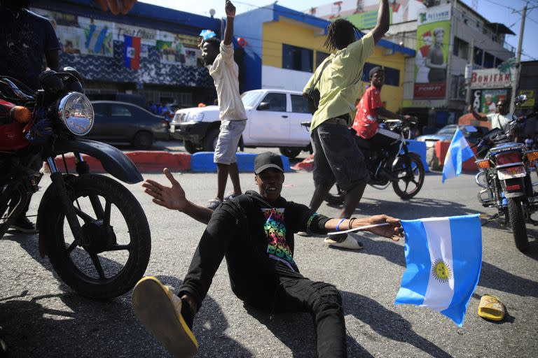 Soccer fans celebrate Argentina's World Cup victory over France in Port-au-Prince, Haiti, Sunday, Dec. 18, 2022. (AP Photo/Odelyn Joseph)