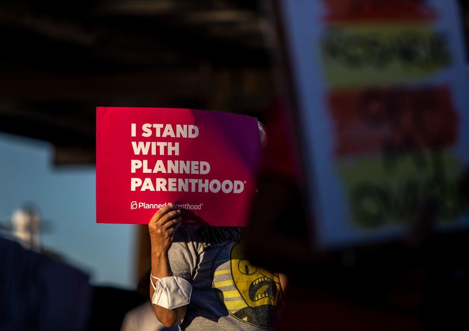 Crystal Lemon of Palm Desert holds up a sign in support of Planned Parenthood during an abortion rights rally organized by Courageous Resistance of the Desert in front of the Palm Springs Courthouse in Palm Springs, Calif., Friday, June 24, 2022. 