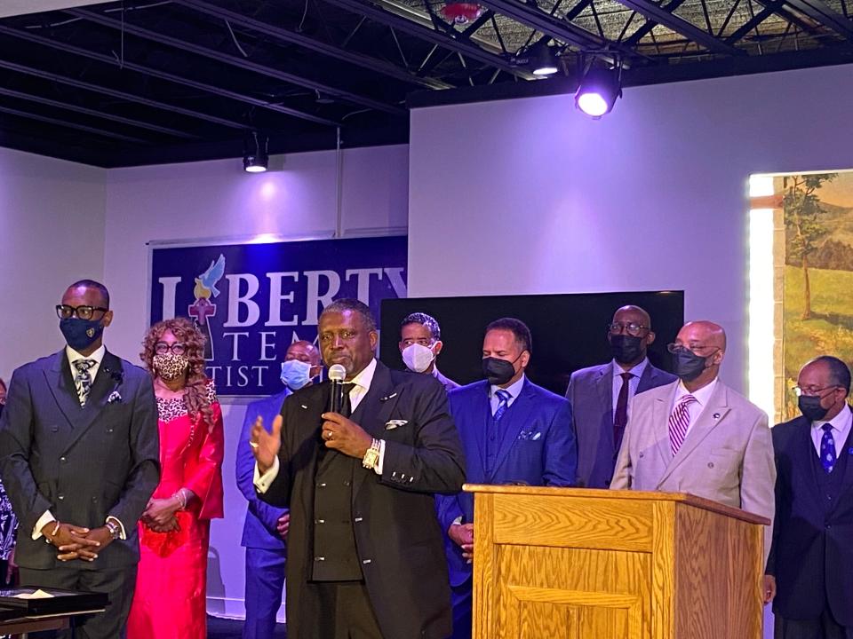 Rev. Steve Bland Jr., senior pastor of Liberty Temple Baptist Church in Detroit and president of the Council of Baptist Pastors of Detroit and Vicinity, speaks June 28, 2022, with other pastors on stage at a meeting. He spoke about their efforts to provide COVID vaccines and tests.