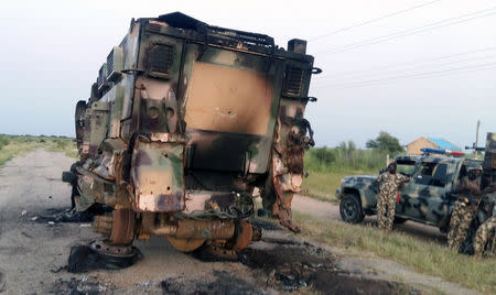 A damaged military vehicle is pictured in the northeast town of Gudumbali, after an attack by members of Islamic State in West Africa (ISWA), Nigeria September 11, 2018. Picture taken September 11, 2018. REUTERS/Kolawole Adewale