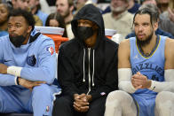 Memphis Grizzlies guard Ja Morant, center, sits on the bench between center Xavier Tillman, left, and forward Dillon Brooks (24) in the second half of an NBA basketball game against the Atlanta Hawks, Friday, Nov. 26, 2021, in Memphis, Tenn. (AP Photo/Brandon Dill)