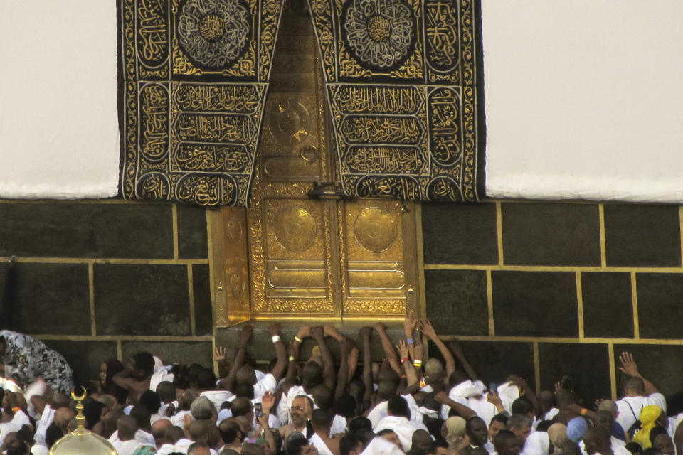 Muslim pilgrims pray in front of the Kaaba door, the cubic building at the Grand Mosque, during the annual hajj pilgrimage in Mecca, Saudi Arabia, Monday, June 26, 2023, before heading to Mina in preparation for the Hajj, the fifth pillar of Islam and one of the largest religious gatherings in the world. (AP Photo/Amr Nabil)