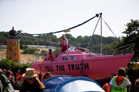 Protestors affiliated with Extinction Rebellion take part in a procession during Glastonbury Festival at Worthy farm in Somerset