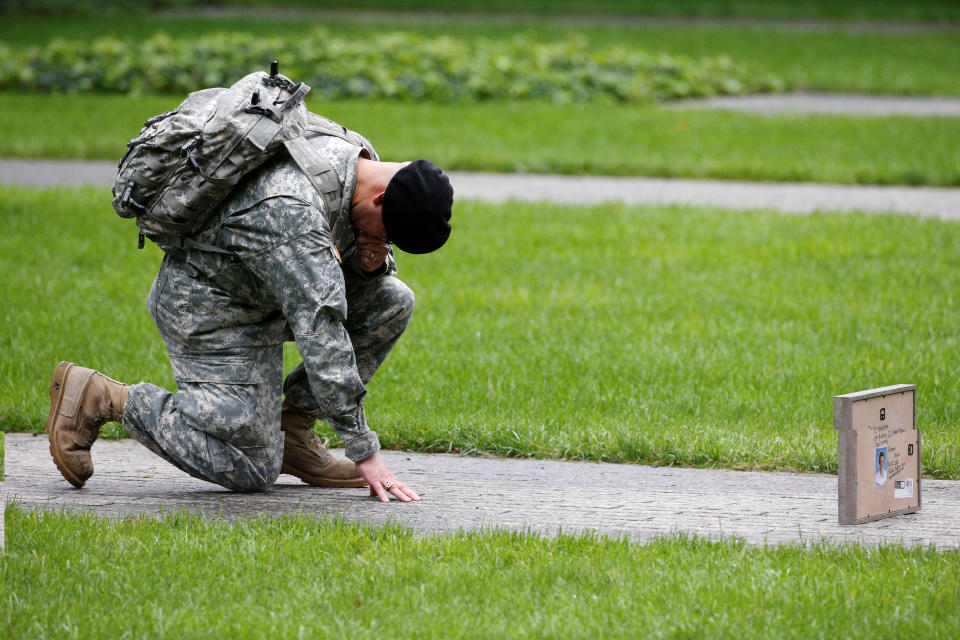 <p>U.S. Army Reserve Sgt. Edwin morales kneels as he honors his cousin Ruben Correa during ceremonies marking the 17th anniversary of the September 11, 2001 attacks on the World Trade Center, at the National 9/11 Memorial and Museum in New York, Sept.11, 2018. (Photo: Brendan McDermid/Reuters) </p>