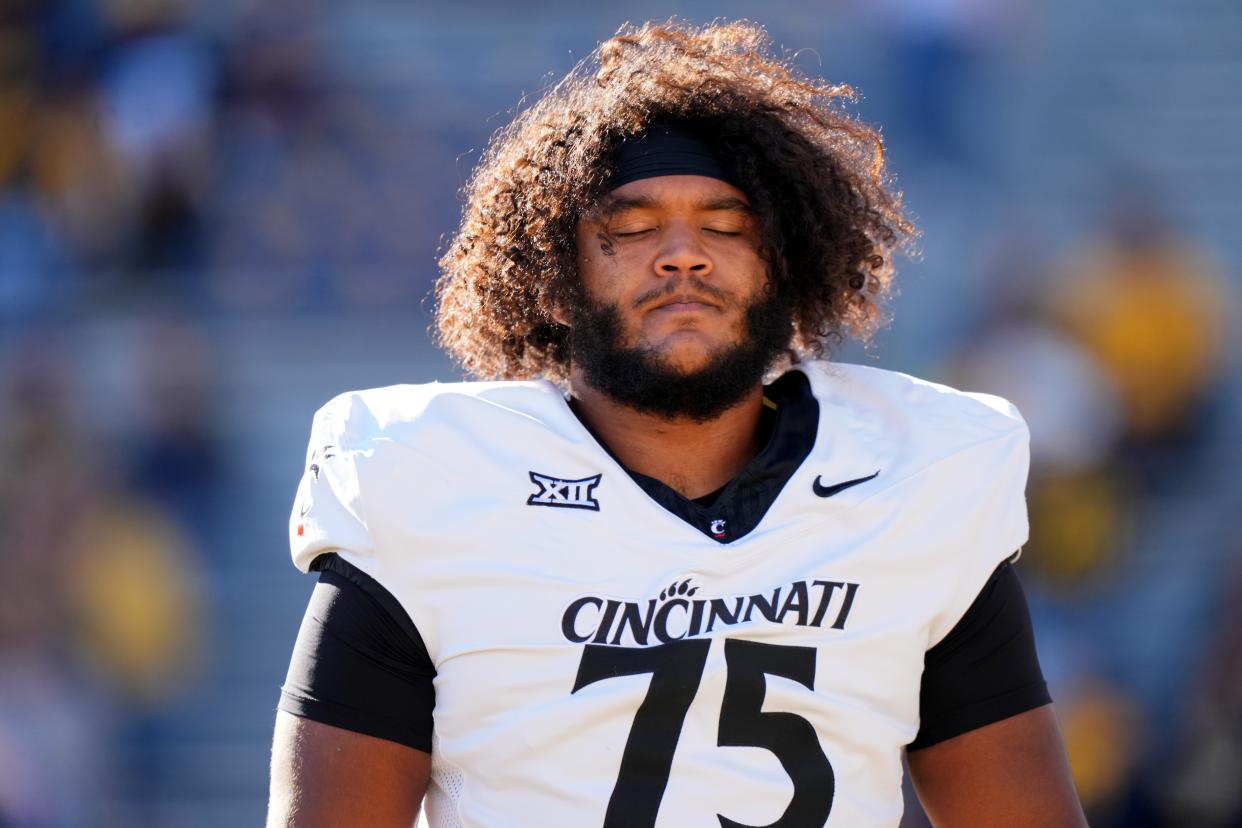 Cincinnati Bearcats offensive lineman John Williams (75) is an aerospace engineer major.