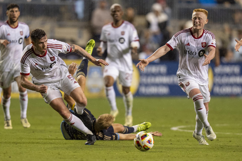 Toronto FC's Kevin Long, left, and Matthew Longstaff, right, go after the ball as they get past Philadelphia Union's Jakob Glesnes, center, during the second half of an MLS soccer match Wednesday, May 29, 2024, in Chester, Pa. (AP Photo/Chris Szagola)