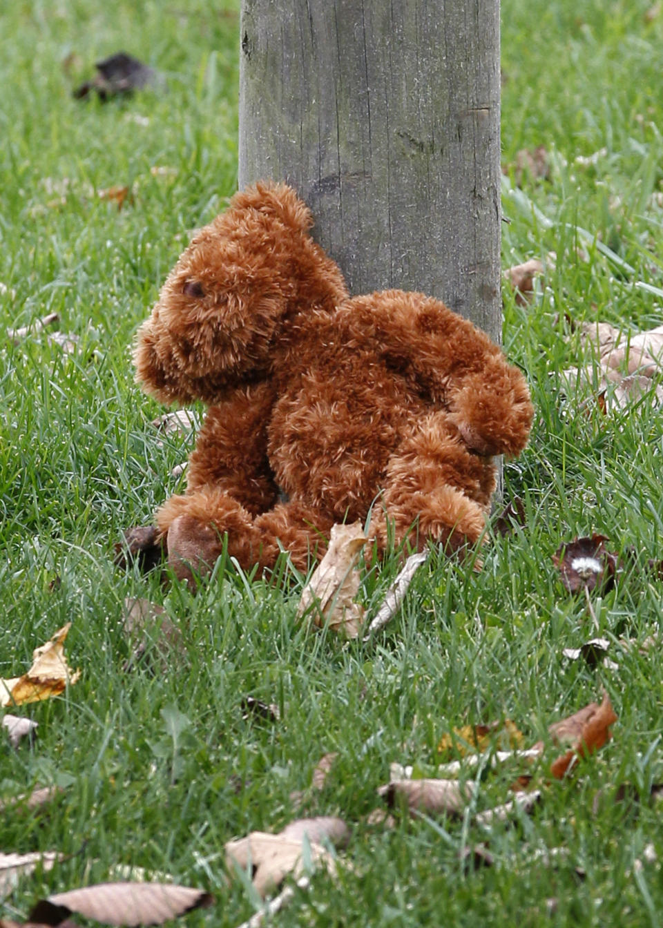 A teddy bear rests at the post of a sign near the entrance to the parking lots for the Pittsburgh Zoo and PPG Aquarium on Monday, Nov. 5, 2012, in Pittsburgh. Zoo officials said a young boy was killed after he fell into the exhibit that was home to a pack of African painted dogs who pounced on the boy and mauled him on Sunday, Nov. 4, 2012. (AP Photo/Keith Srakocic)