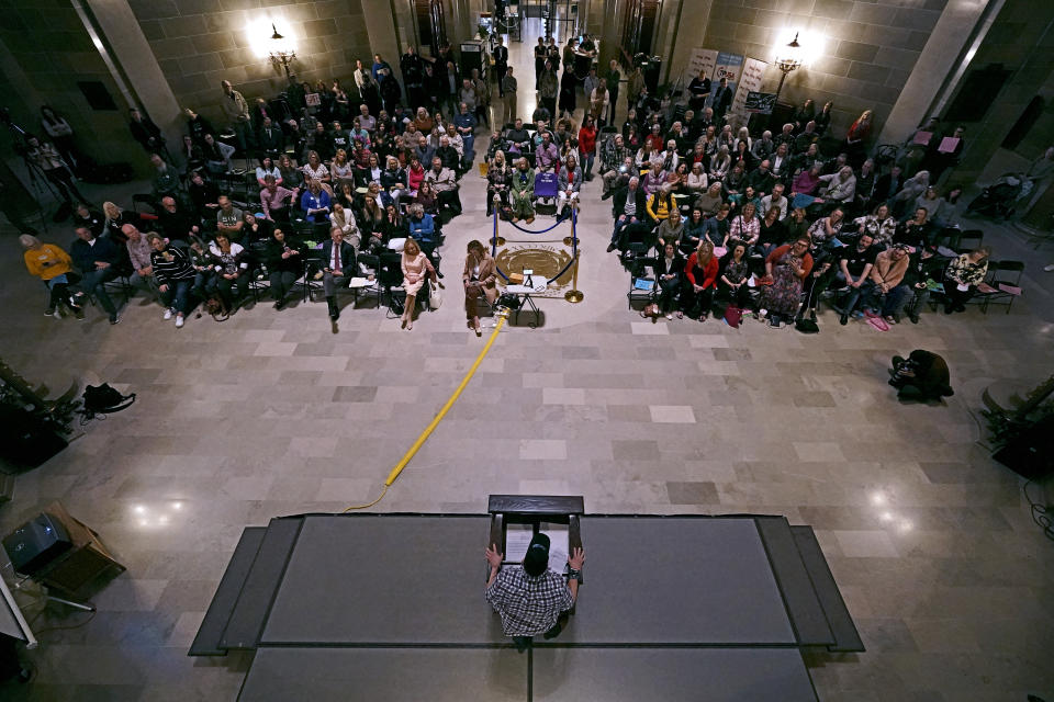 People listen to a speaker during a rally in favor of a ban on gender-affirming health care legislation, Monday, March 20, 2023, at the Missouri Statehouse in Jefferson City, Mo. (AP Photo/Charlie Riedel)