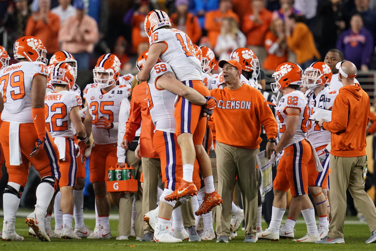 Jan 7, 2019; Santa Clara, CA, USA; Clemson Tigers quarterback Trevor Lawrence (16) is greeted defensive tackle Jordan Williams (59) and head coach Dabo Swinney during the fourth quarter in the 2019 College Football Playoff Championship game against the Alabama Crimson Tide at Levi's Stadium. Mandatory Credit: Kyle Terada-USA TODAY Sports