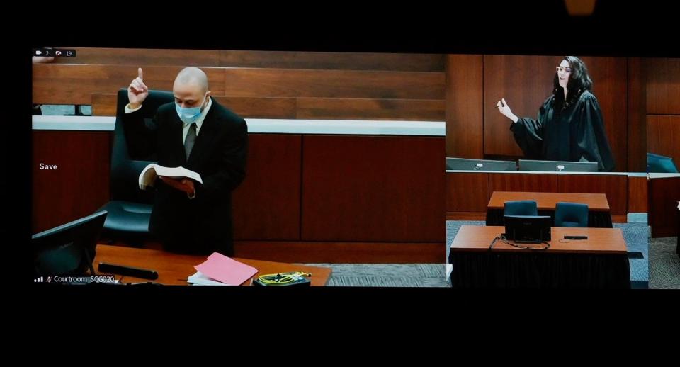 Darrell Brooks reads from the Bible during jury selection on Tuesday, Oct. 4, 2022.