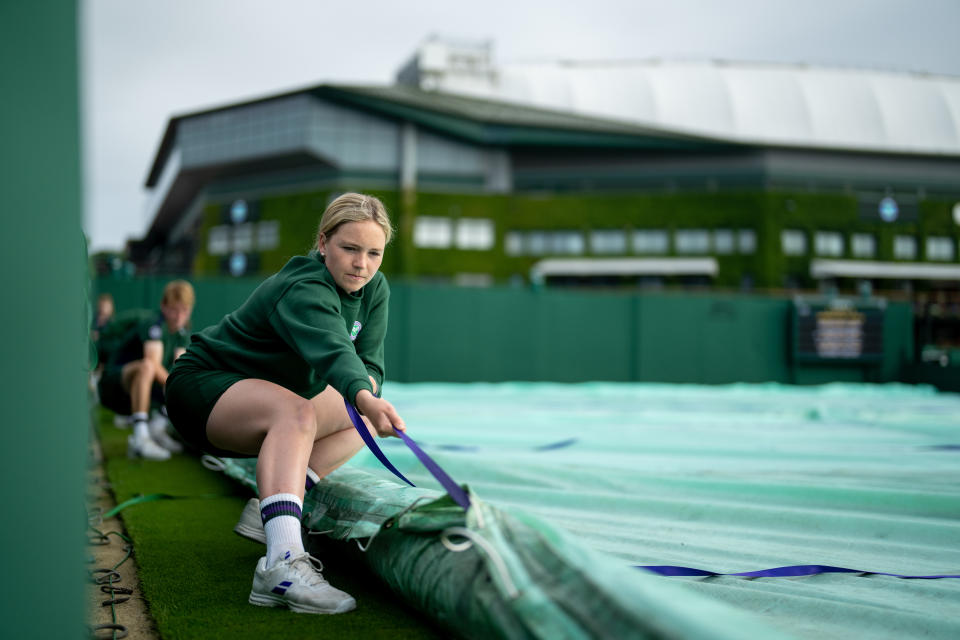 <p>Court Coverers remove the covers on Court 4 in the early morning light on day four of Wimbledon at The All England Lawn Tennis and Croquet Club, Wimbledon. Picture date: Thursday July 1, 2021.</p>
