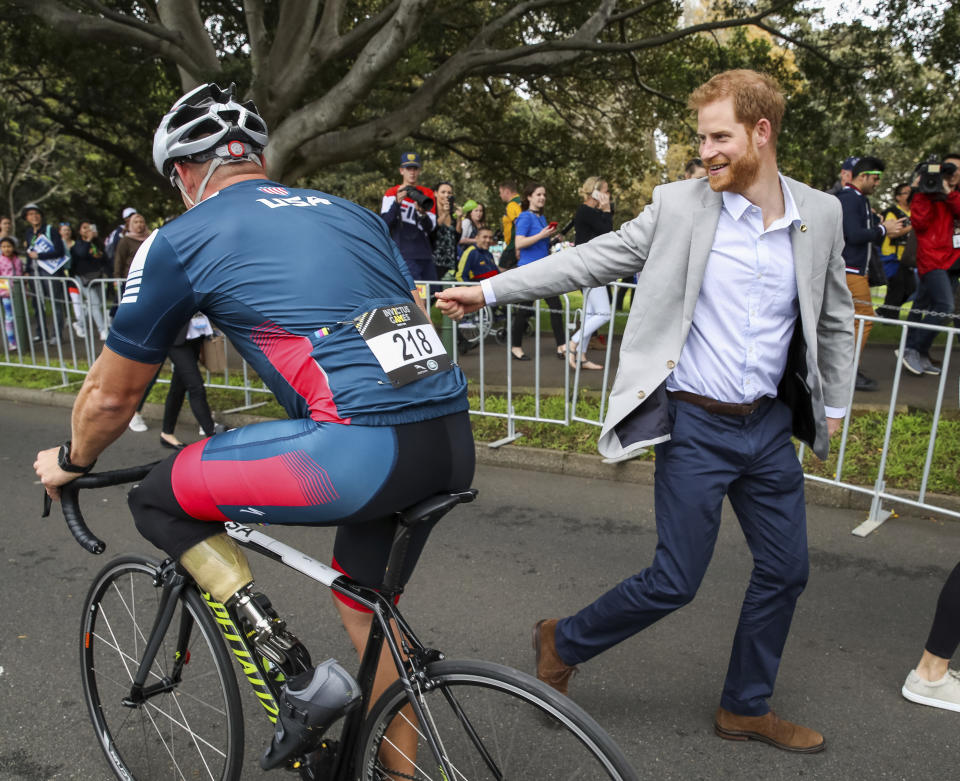 Britain's Prince Harry, right, greets a competitor at the Invictus Games Sydney 2018 at Sydney Olympic Park Sunday, Oct. 21, 2018 in Sydney, Australia. Prince Harry and his wife Meghan are on day four of their 16-day tour of Australia and the South Pacific. (Chris Jackson/Pool Photo via AP)