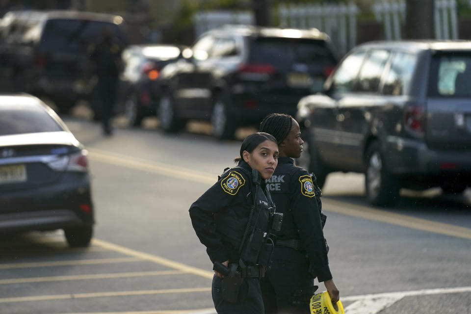 Law enforcement personnel gather at the scene where two officers were reported shot, Tuesday, Nov. 1, 2022, in Newark, N.J. Two officers were being treated for injuries at a nearby hospital, according to the Essex County prosecutor's office. (AP Photo/Seth Wenig)
