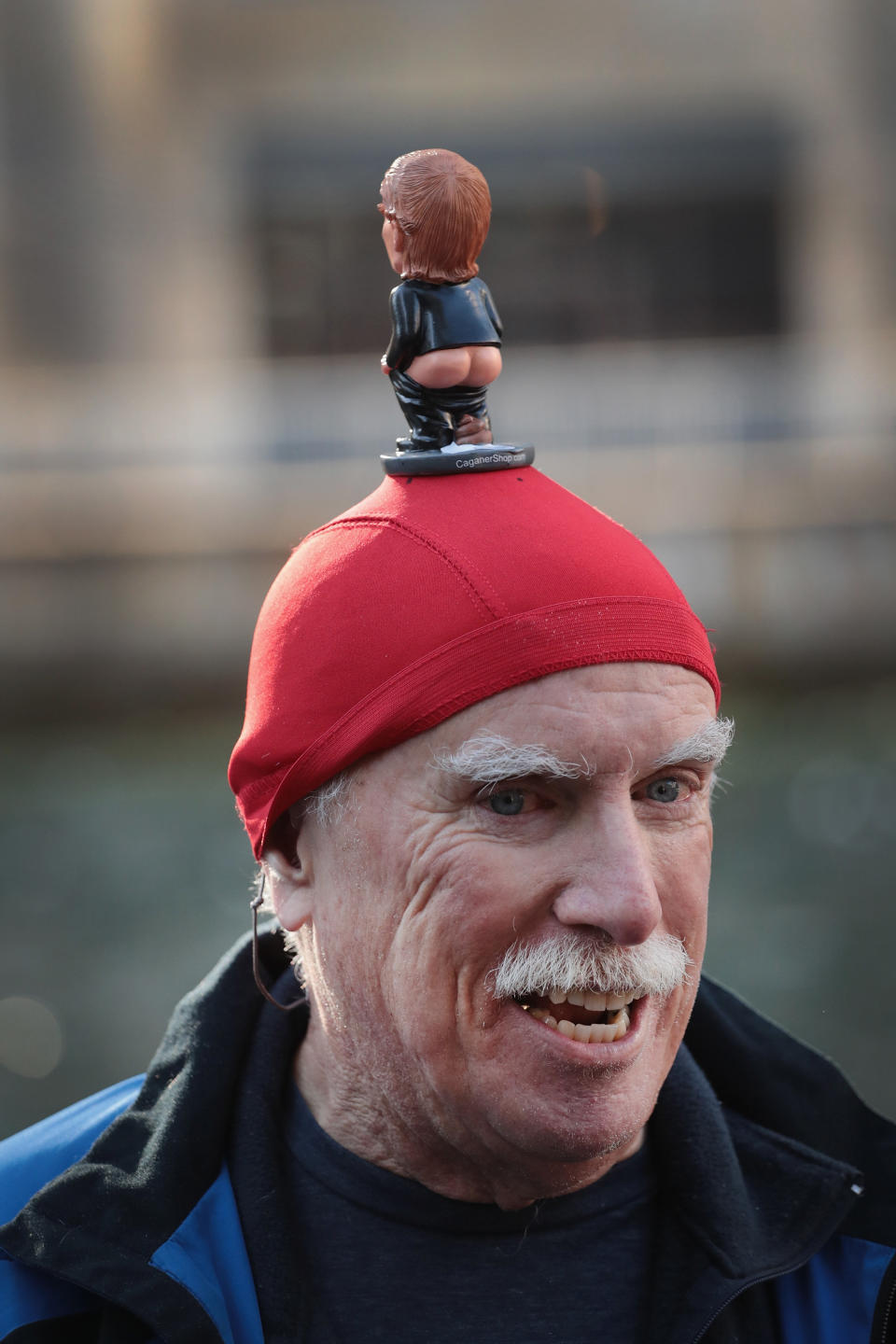 Peter Buck, from Olympia Washington, waits with activists across from Trump Tower before pulling down his pants.&nbsp;