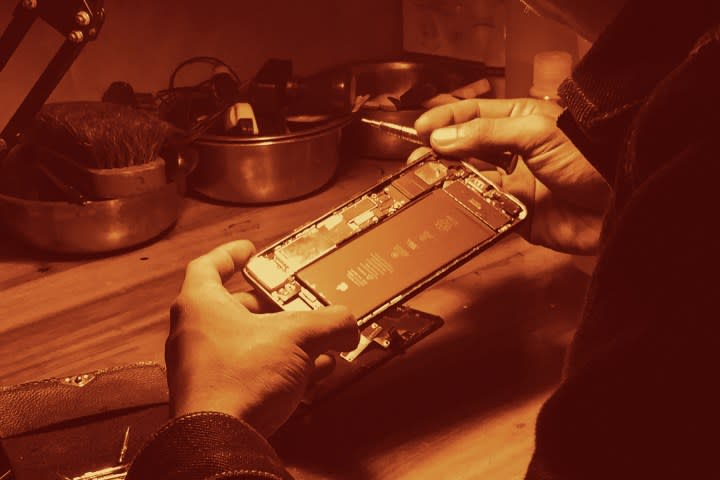 A person repairing an iPhone