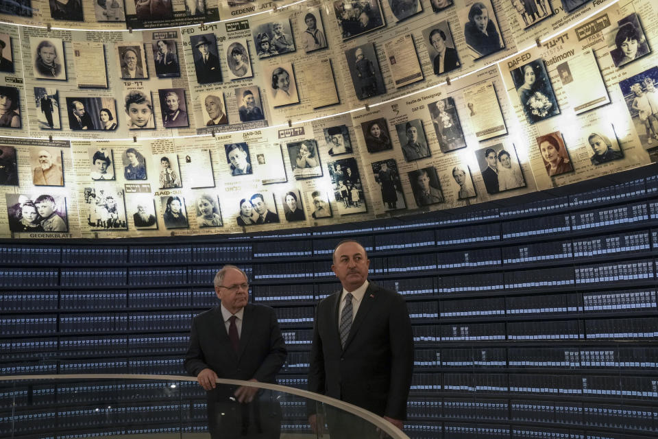 Turkish Foreign Minister Mevlut Cavusoglu, right, visits with Dani Dayan, Yad vashem chairman, left, at the Hall of Names in the Yad Vashem World Holocaust Remembrance Center in Jerusalem, Wednesday, May 25, 2022. (AP Photo/ Maya Alleruzzo)