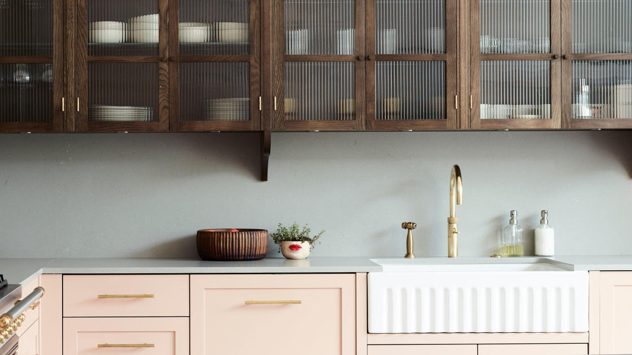  pink cabinets and large butler's sink with wooden fluted glass upper cabinets 