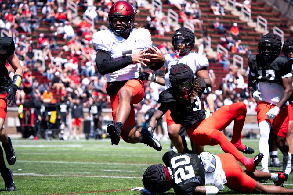 Freshman quarterback Samaj Jones (5) leaps over fallen defensive back Mehdi Miller (20) and into the end zone during his time running the offense.