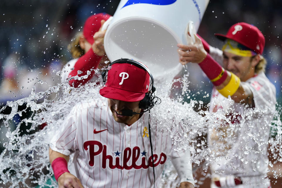 Philadelphia Phillies' Dalton Guthrie, center, is doused by Bryson Stott, right, and Alec Bohm after a baseball game against the Washington Nationals, Friday, Sept. 9, 2022, in Philadelphia. (AP Photo/Matt Slocum)