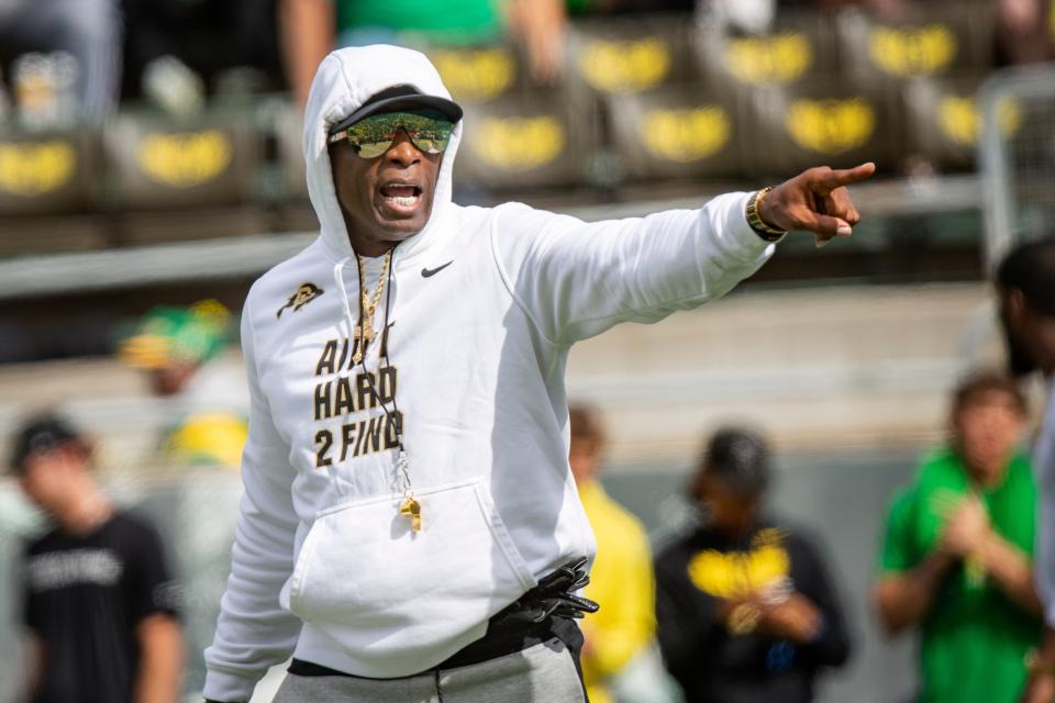 Deion Sanders walks the field during warmups before Colorado's game against Oregon.