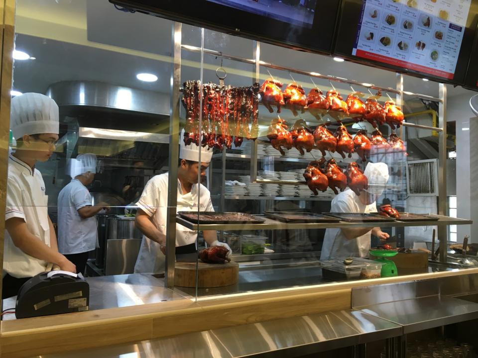 <p>Customers ordering at Hawker Chan will get to see chefs in action through a transparent glass behind the counter. </p>