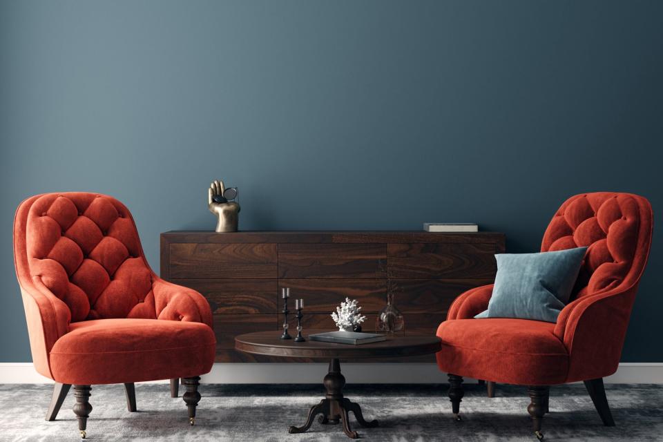 Elegant dark interior with bright red armchairs