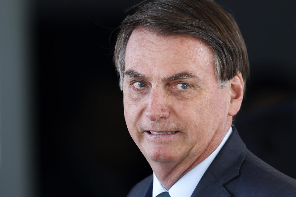 Brazil's President Jair Bolsonaro speaks to journalists after meeting with military commanders at the Defense Ministry in Brasilia, Brazil, Tuesday, Jan. 7, 2020. Bolsonaro spoke about maintaining commercial ties with Iran this morning, said he would speak to his foreign minister about talks with Iran, and reiterated that Brazil opposes terrorism. (AP Photo/Eraldo Peres)