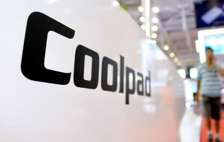 A visitor walks past a Coolpad stand at an exhibition in Nanjing, Jiangsu province, China July 3, 2015. REUTERS/Stringer/Files