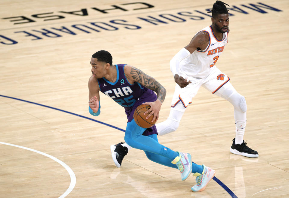 Charlotte Hornets' P.J. Washington drives past New York Knicks' Nerlens Noel during the first half of an NBA basketball game Tuesday, April 20, 2021, in New York. (Sarah Stier/Pool Photo via AP)