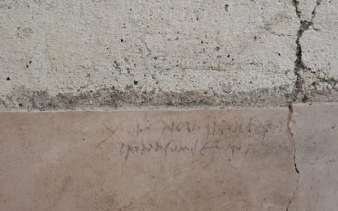 The inscription, in charcoal, was written in October AD 79 - meaning Vesuvius erupted three months later than previously thought - Credit: Pompeii