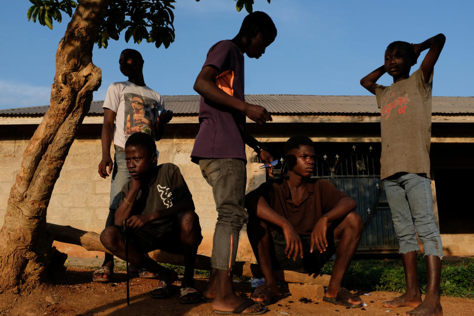 A boy gets a haircut as his friends wait in Adanse Meduma, Ashanti region, Ghana. (Photo: Francis Kokoroko/Reuters)