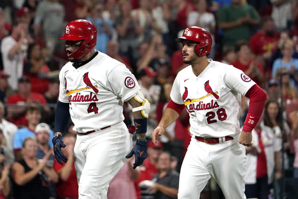 St. Louis Cardinals' Yadier Molina (4) celebrates after hitting a two-run home run as teammate Nolan Arenado (28) watches during the fourth inning of a baseball game against the Cincinnati Reds Friday, Sept. 10, 2021, in St. Louis. (AP Photo/Jeff Roberson)