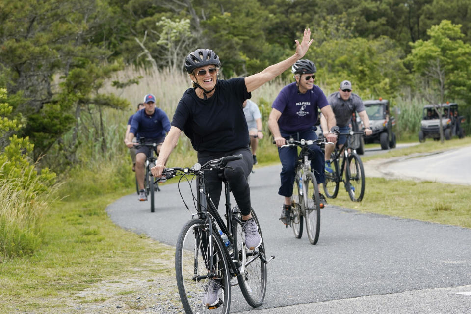 First lady Jill Biden waves as she rides her bike with President Joe Biden in Rehoboth Beach, Del., Thursday, June 3, 2021. The Biden's are spending a few days in Rehoboth Beach to celebrate first lady Jill Biden's 70th birthday. (AP Photo/Susan Walsh)