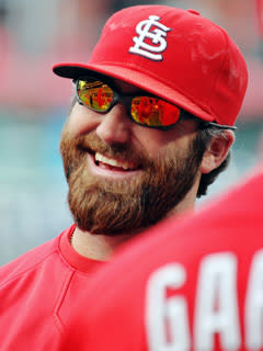 Jason Motte talks with teammates during batting practice before a September game in Philadelphia. He wears prescription eyewear off the mound