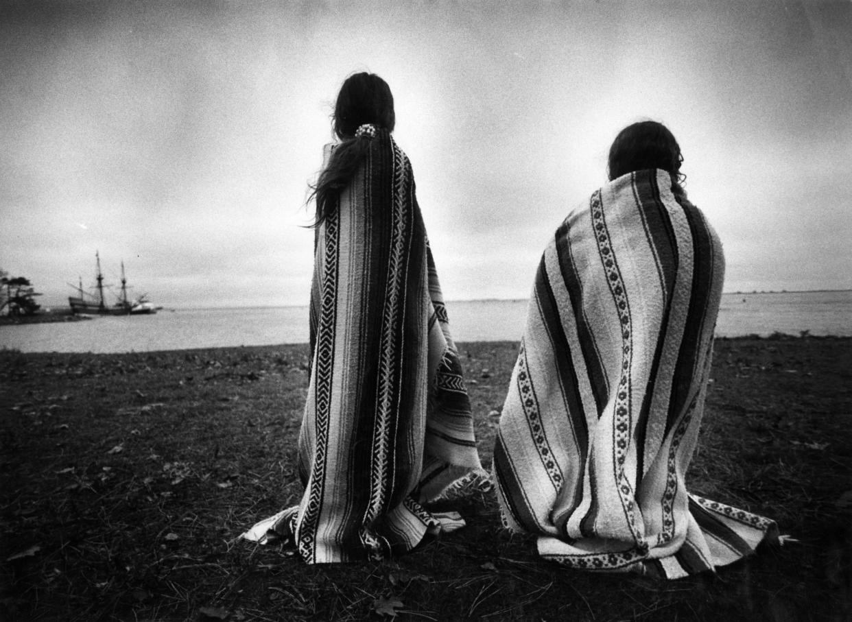 Sisters Weetoomoo Carey, 8, left, and Jackolynn Carey, 5, Wampanoag Nipmucs from Mashpee, looked across to the Mayflower replica anchored near Plymouth Rock in Plymouth, Mass. on Nov. 26, 1991. They were with a group of Native Americans gathered for a day of mourning in counterpoint to the Pilgrims' Thanksgiving. (Photo: Suzanne Kreiter/The Boston Globe via Getty Images)