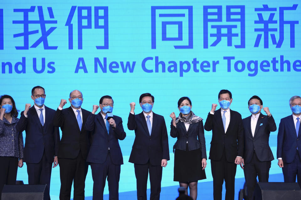 John Lee, center, former No. 2 official in Hong Kong, and the only candidate for the city's top job, attends his 2022 chief executive electoral campaign rally in Hong Kong, Friday, May 6, 2022. China is moving to install lee as the new leader of Hong Kong in the culmination of a sweeping political transformation that has gutted the Asian financial center's democratic institutions and placed it ever more firmly under Beijing's control. (AP Photo/Kin Cheung)